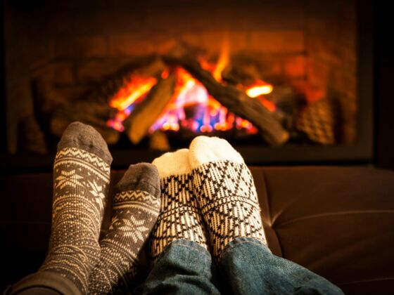 Romantic couple sitting in front of the fireplace at Auberge West Brome