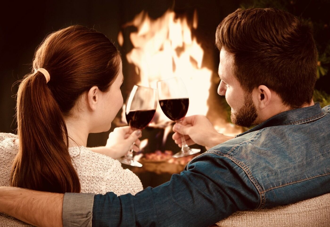couple with glass of wine in front of the fireplace at Ripplevoce, Hotel & Spa